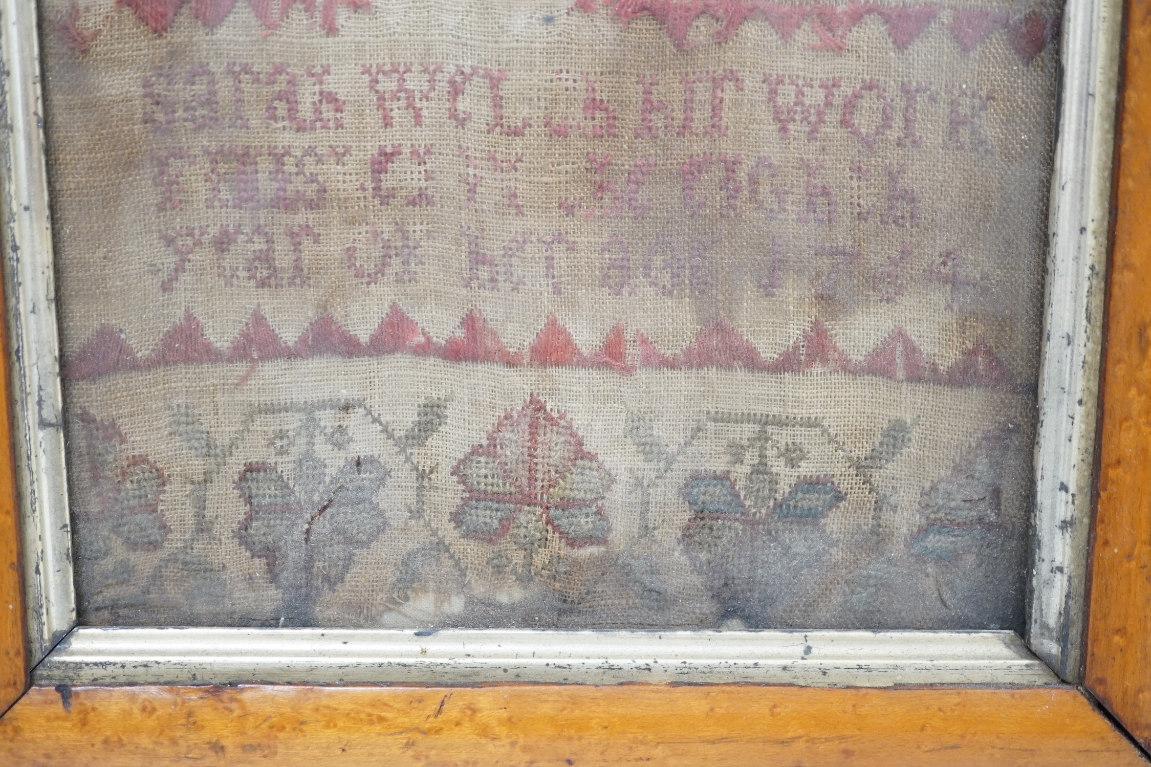 A George III needlework sampler in later maple frame, 42 x 18cm